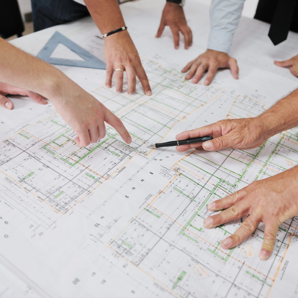 Team,Of,Architects,People,In,Group,On,Construciton,Site,Check